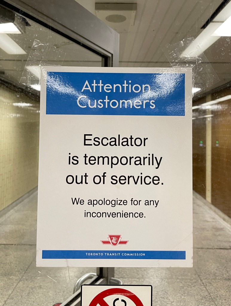 “Attention[,] Customers” in TTC font. “Escalator is temporarily out of service”