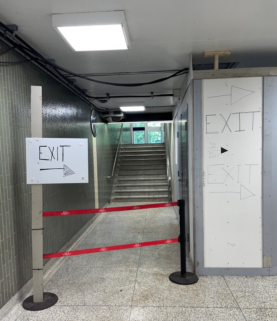Nothing but hand-scrawled signs saying EXIT plus arrow